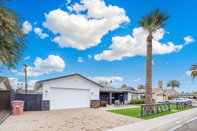 ranch-style house featuring a patio area, a garage, and a front lawn