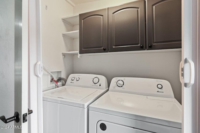 washroom featuring washer and dryer and cabinets