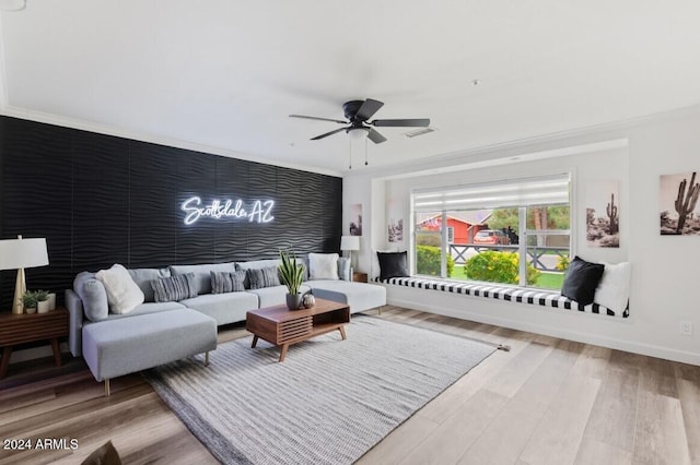 living room featuring hardwood / wood-style flooring, ceiling fan, and ornamental molding