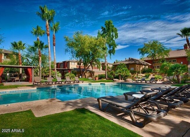 outdoor pool with a patio area