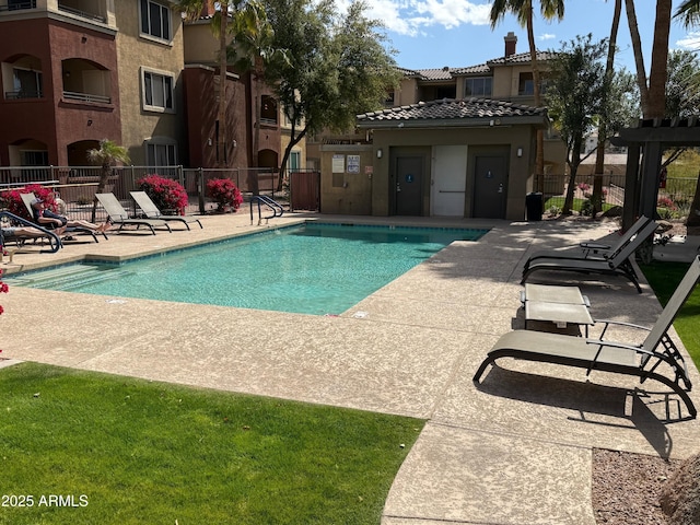 pool featuring fence and a patio