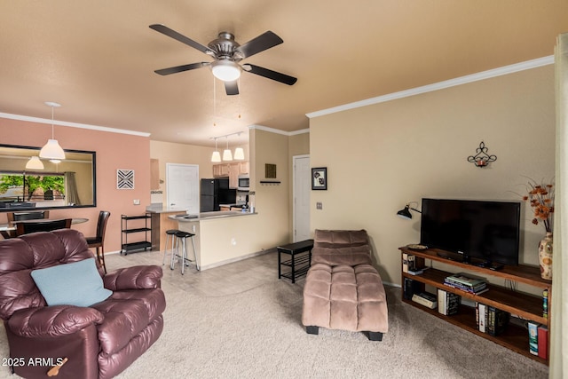 living room with light carpet, ornamental molding, a ceiling fan, and baseboards