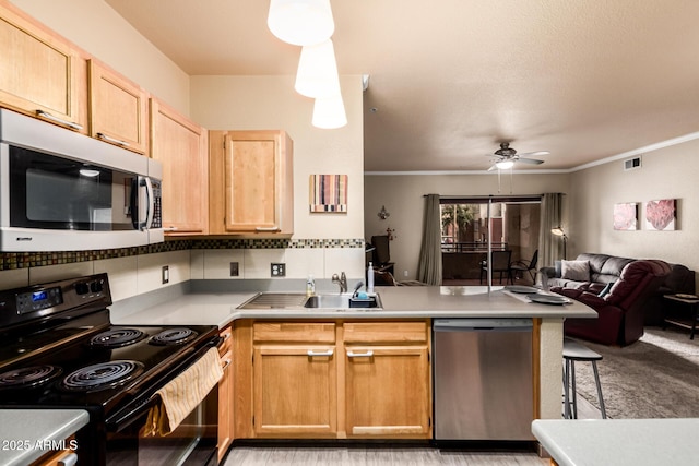 kitchen featuring open floor plan, black range with electric stovetop, a peninsula, light brown cabinetry, and stainless steel dishwasher