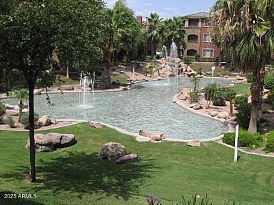 exterior space featuring a water view and a lawn