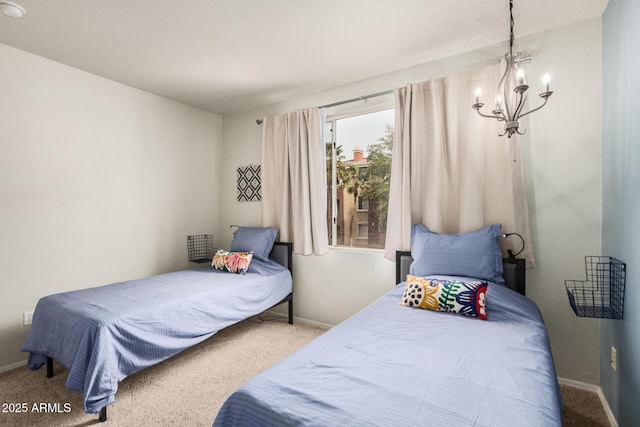 bedroom with a chandelier, carpet, and baseboards