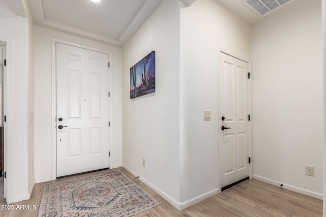 entrance foyer featuring light wood finished floors and baseboards