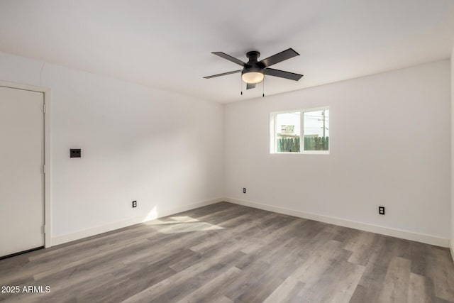 unfurnished room featuring ceiling fan, baseboards, and wood finished floors