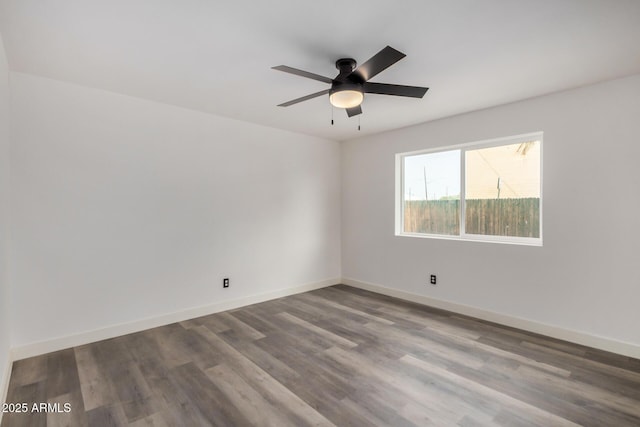 unfurnished room with a ceiling fan, baseboards, and wood finished floors