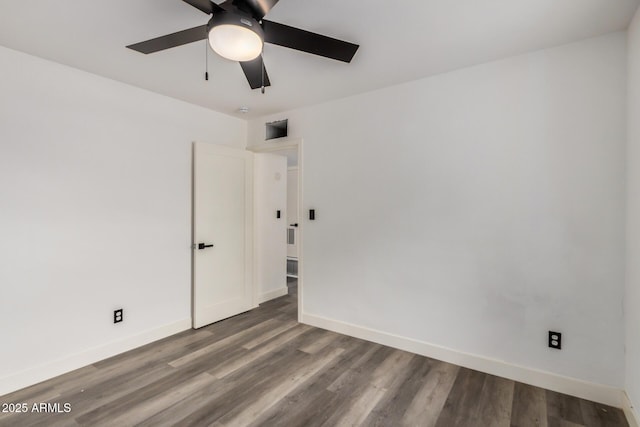 empty room with a ceiling fan, baseboards, and wood finished floors