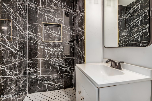 bathroom featuring a shower and vanity