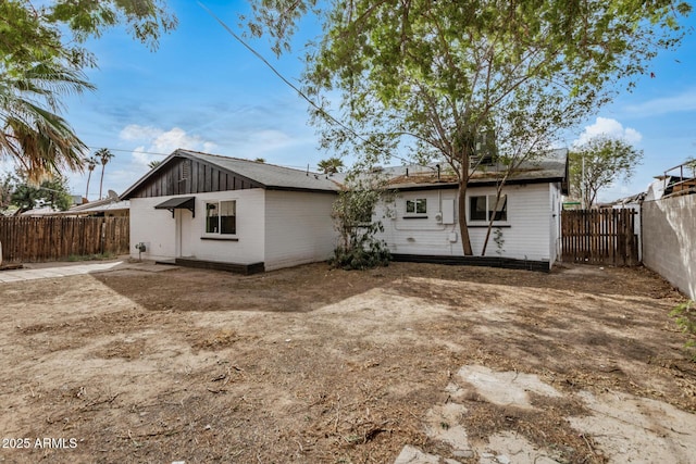 back of property featuring a fenced backyard and board and batten siding