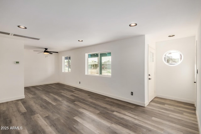 unfurnished room featuring recessed lighting, baseboards, and wood finished floors