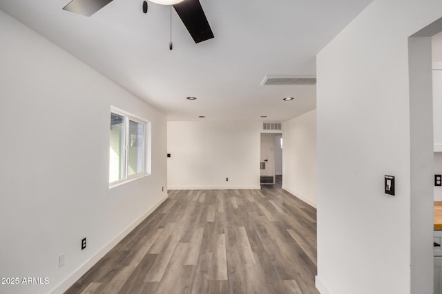 unfurnished room with recessed lighting, visible vents, ceiling fan, wood finished floors, and baseboards