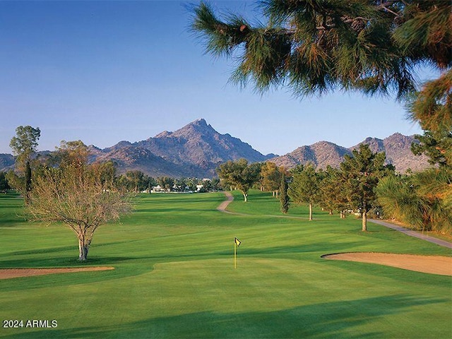 view of home's community featuring a yard and a mountain view