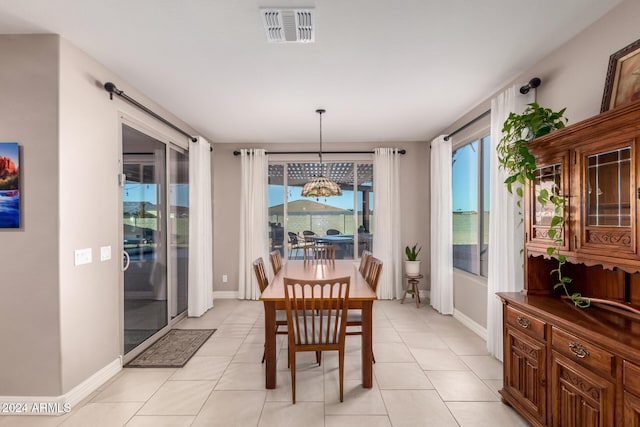 tiled dining space with an inviting chandelier