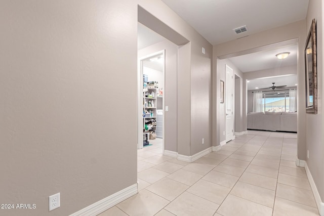 corridor featuring light tile patterned flooring