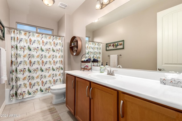 full bathroom featuring tile patterned flooring, vanity, toilet, and shower / tub combo