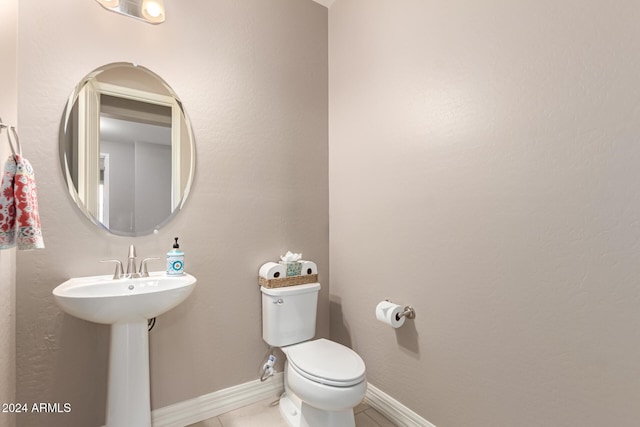 bathroom with tile patterned flooring and toilet