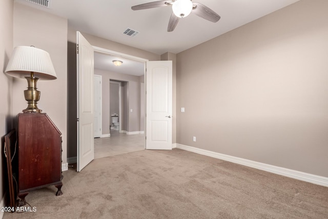 spare room featuring ceiling fan and light carpet