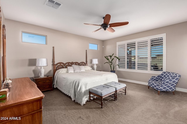 bedroom featuring carpet, ceiling fan, and multiple windows