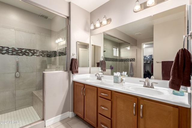 bathroom featuring tile patterned flooring, vanity, and an enclosed shower