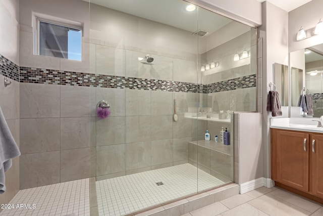 bathroom featuring tile patterned flooring, vanity, and an enclosed shower