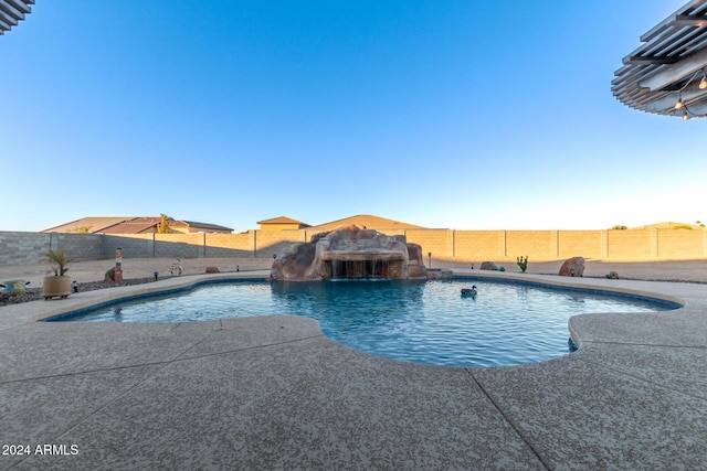 view of swimming pool with pool water feature