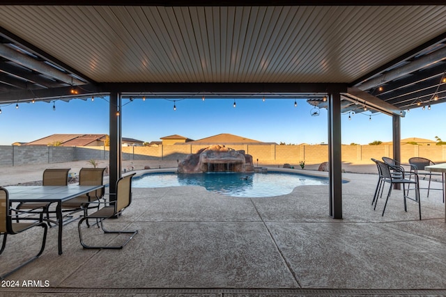 view of pool featuring pool water feature and a patio