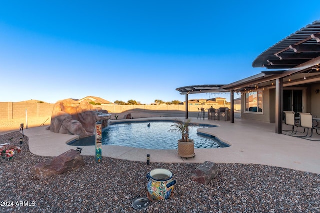 view of swimming pool featuring pool water feature and a patio