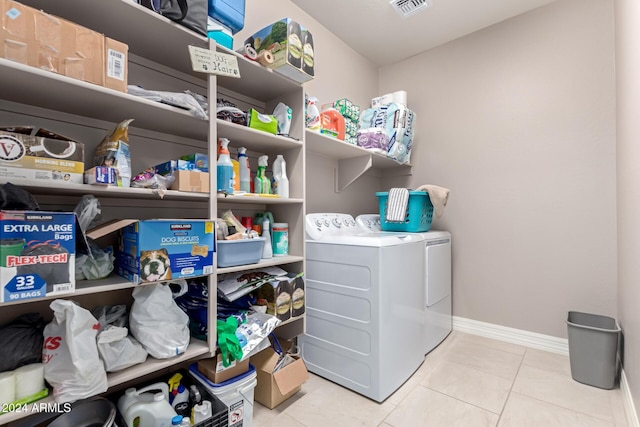 washroom featuring light tile patterned flooring and washing machine and dryer