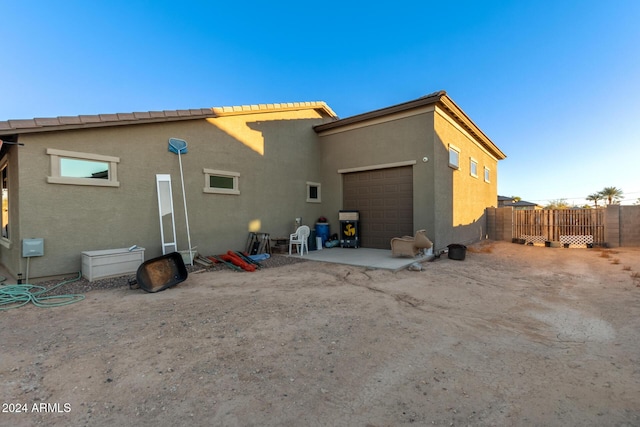 back of property with a garage