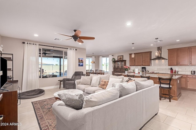 living room featuring ceiling fan and light tile patterned flooring