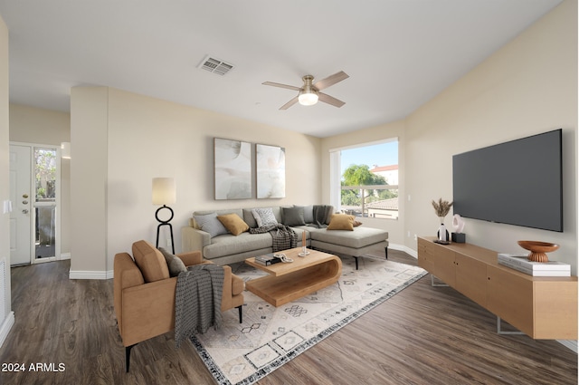 living room featuring ceiling fan and dark hardwood / wood-style flooring