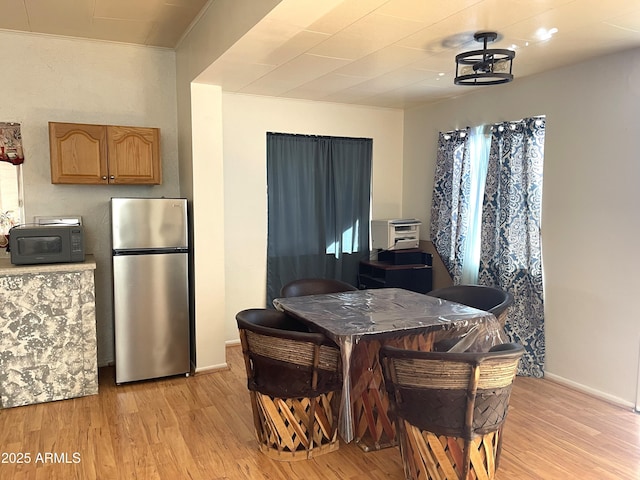 dining area with light hardwood / wood-style flooring