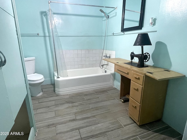 bathroom with shower / bath combination with curtain and toilet