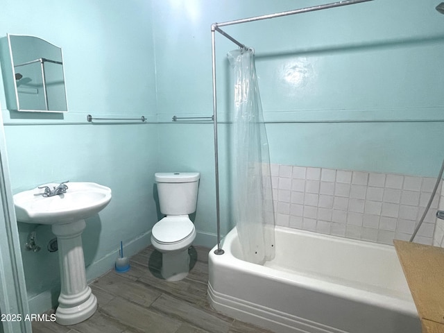 bathroom featuring shower / bath combination with curtain, toilet, and hardwood / wood-style floors