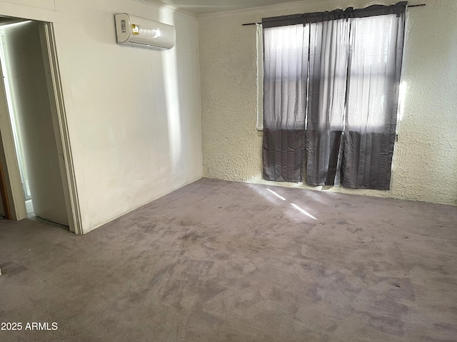 unfurnished room with an AC wall unit and carpet floors