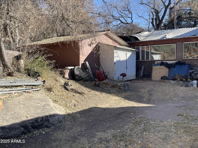 view of side of home with a storage unit