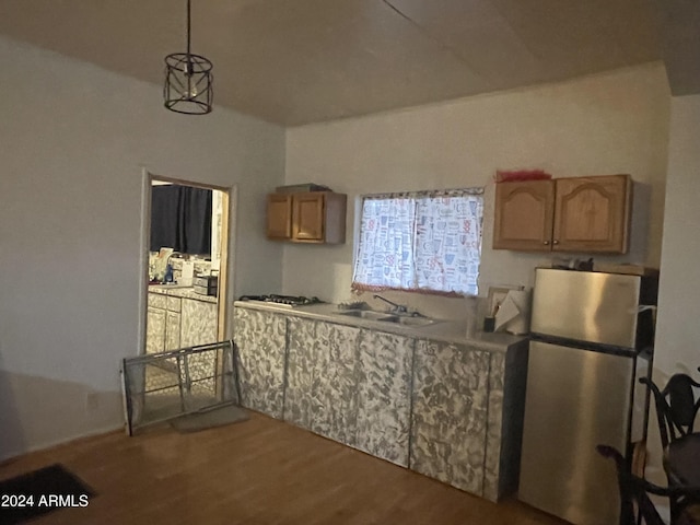 kitchen with decorative light fixtures, dark hardwood / wood-style flooring, sink, and stainless steel appliances