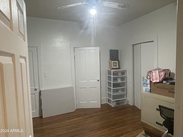 unfurnished bedroom featuring ceiling fan, dark hardwood / wood-style flooring, and two closets