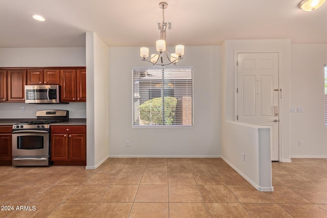 kitchen with an inviting chandelier, appliances with stainless steel finishes, hanging light fixtures, and plenty of natural light