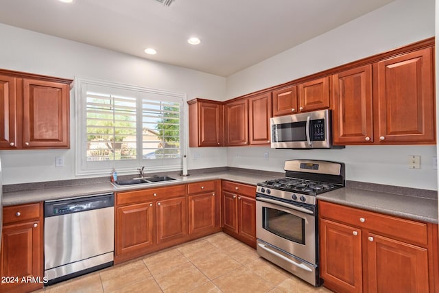 kitchen featuring light tile patterned flooring, appliances with stainless steel finishes, and sink