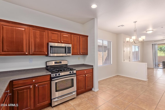 kitchen with light tile patterned floors, decorative light fixtures, stainless steel appliances, and a chandelier