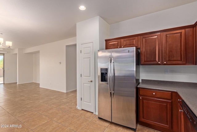 kitchen featuring light tile patterned flooring, stainless steel fridge, dishwasher, and a notable chandelier