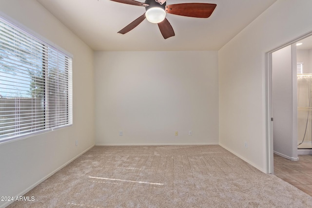 carpeted empty room featuring ceiling fan