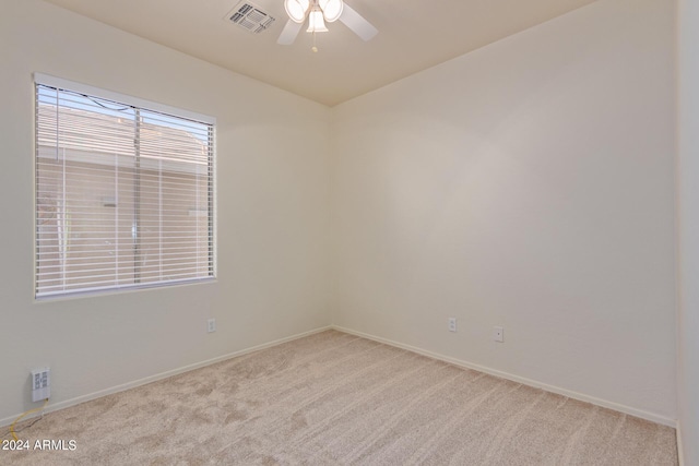 unfurnished room featuring light carpet and ceiling fan