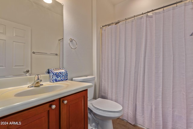 bathroom with vanity, tile patterned flooring, and toilet