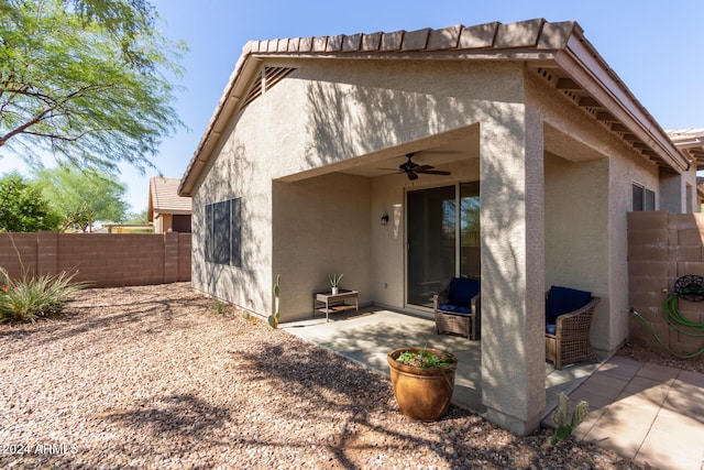 back of property featuring a patio area and ceiling fan