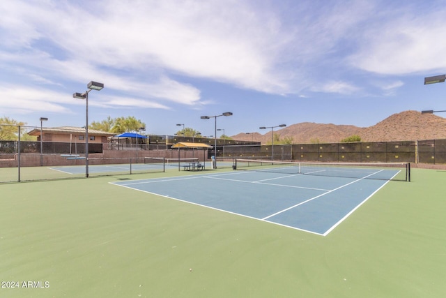 view of tennis court with a mountain view