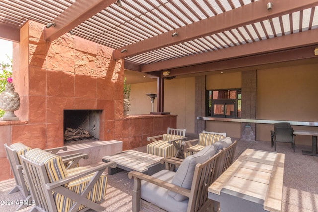 view of patio / terrace with an outdoor living space with a fireplace and a pergola